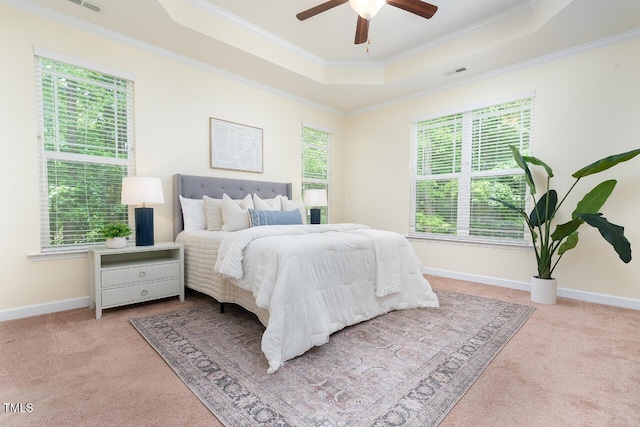 bedroom featuring visible vents, carpet, ornamental molding, and a raised ceiling