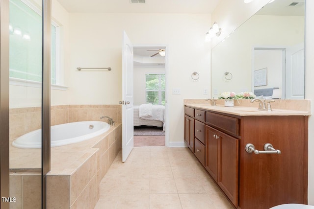 ensuite bathroom featuring tile patterned flooring, double vanity, ceiling fan, connected bathroom, and a sink