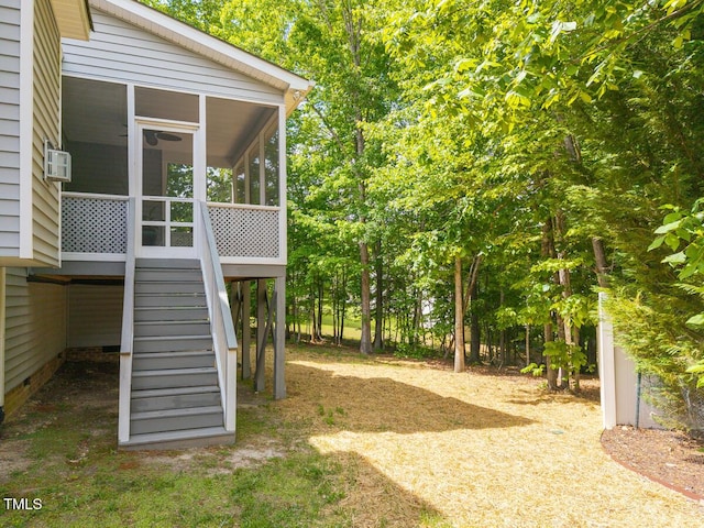 view of yard with stairs and a sunroom