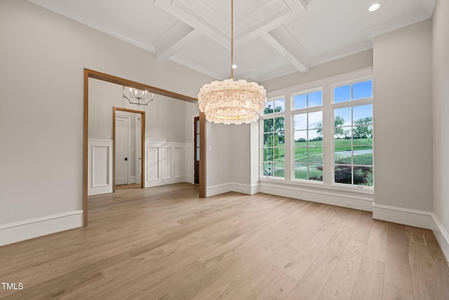 unfurnished dining area with beamed ceiling, a chandelier, light wood finished floors, and coffered ceiling