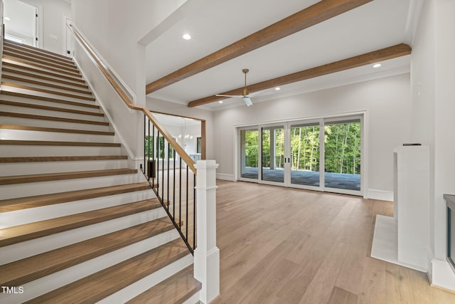 stairs with recessed lighting, baseboards, beam ceiling, and wood finished floors