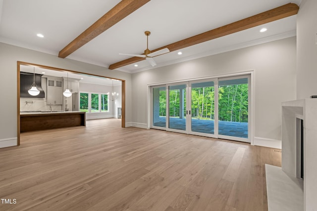 unfurnished living room featuring a fireplace, beamed ceiling, light wood-style floors, baseboards, and ceiling fan
