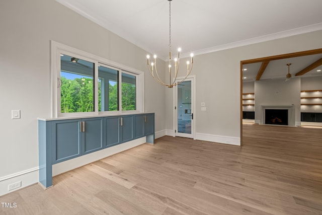 unfurnished dining area with a fireplace, beam ceiling, baseboards, light wood finished floors, and a notable chandelier