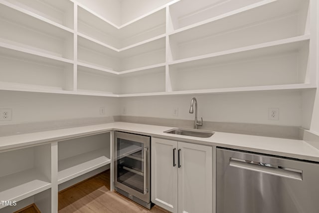 pantry with a sink and beverage cooler
