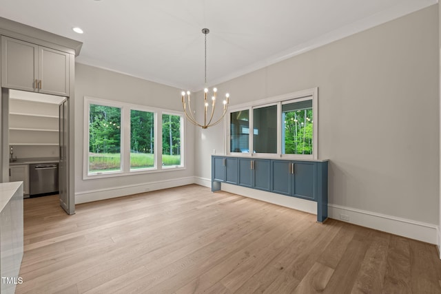unfurnished dining area with an inviting chandelier, baseboards, light wood-style floors, and a wealth of natural light