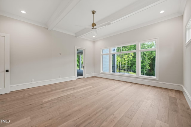 empty room with ornamental molding, beam ceiling, baseboards, ceiling fan, and light wood-type flooring