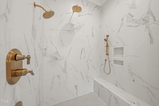 bathroom with a marble finish shower