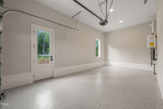 garage with recessed lighting and a garage door opener