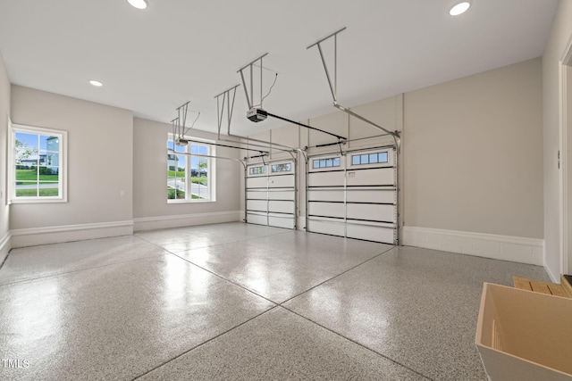 garage with baseboards, a garage door opener, and recessed lighting