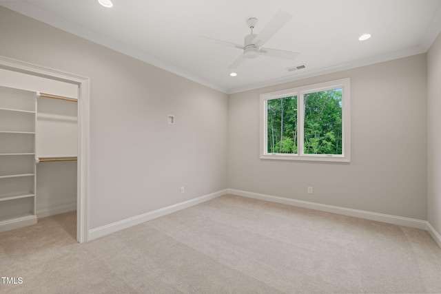 unfurnished bedroom with light colored carpet, baseboards, visible vents, and a spacious closet