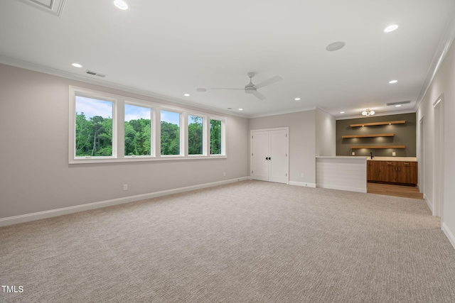 unfurnished living room with baseboards, ornamental molding, and light carpet