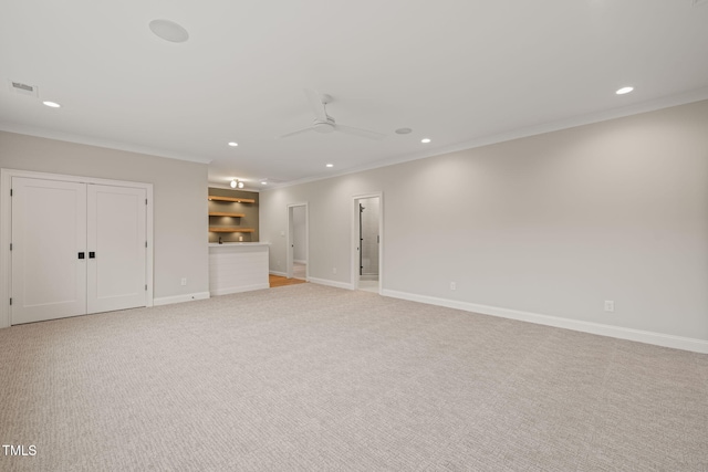 unfurnished living room with recessed lighting, ornamental molding, a ceiling fan, and light carpet
