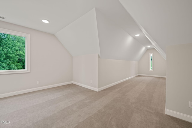 additional living space with carpet flooring, recessed lighting, baseboards, and lofted ceiling