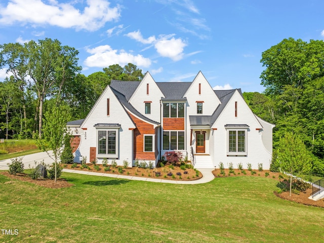 modern farmhouse style home with a front yard