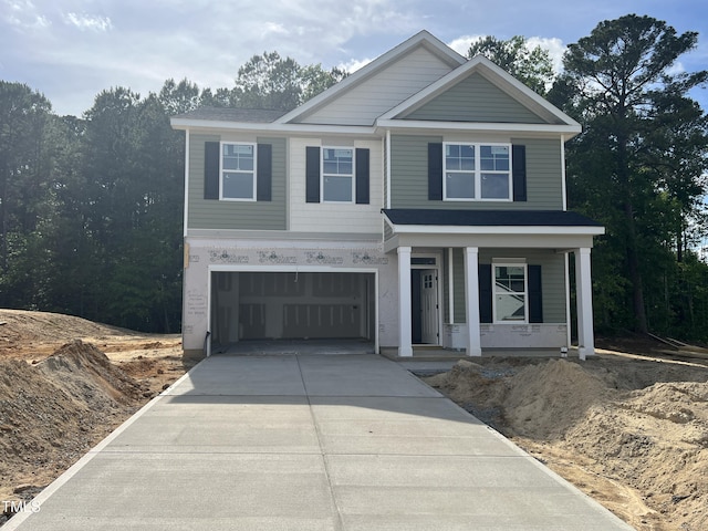 183 Pecan Valley Way, Four Oaks, NC 27524 - view of front facade featuring covered porch, driveway, and a garage