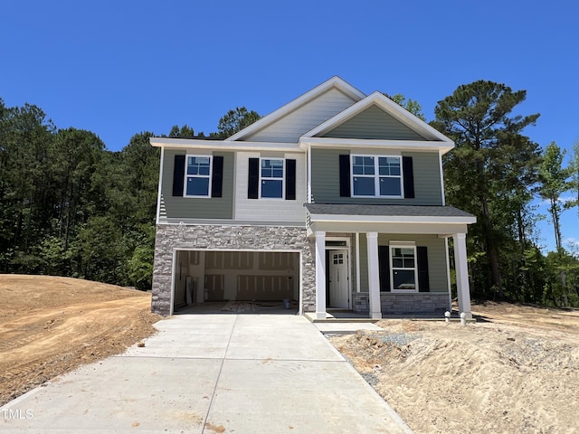 183 Pecan Valley Way, Four Oaks, NC 27524 - view of front of property featuring stone siding, concrete driveway, covered porch, and a garage