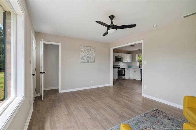 11504 Bissette Rd, Middlesex, NC 27557 - unfurnished living room featuring baseboards, a ceiling fan, visible vents, and light wood-style floors