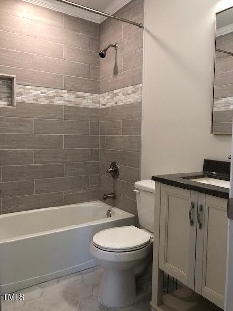 full bathroom featuring toilet, washtub / shower combination, and vanity