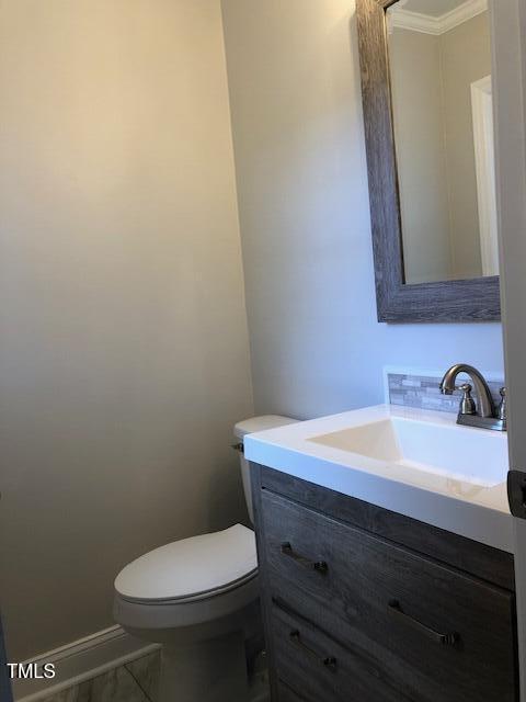 half bath featuring toilet and vanity