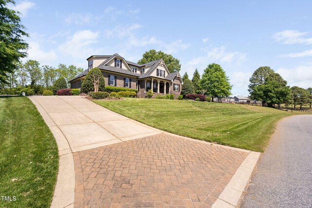 154 Sicily Dr, Clayton, NC 27527 - view of front of house featuring decorative driveway and a front lawn