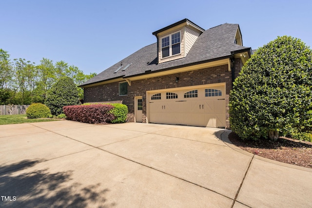 154 Sicily Dr, Clayton, NC 27527 - view of side of property with brick siding, driveway, a shingled roof, and an attached garage