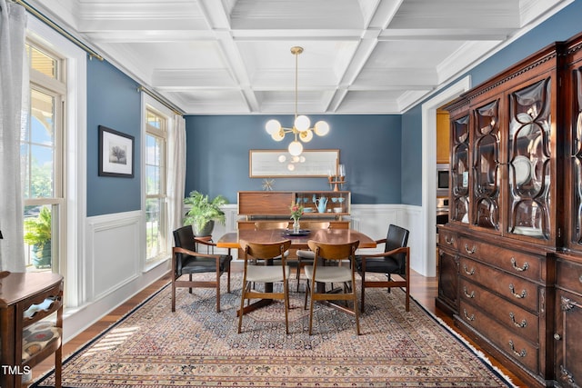 154 Sicily Dr, Clayton, NC 27527 - dining area with wood finished floors, healthy amount of natural light, wainscoting, beam ceiling, and a chandelier