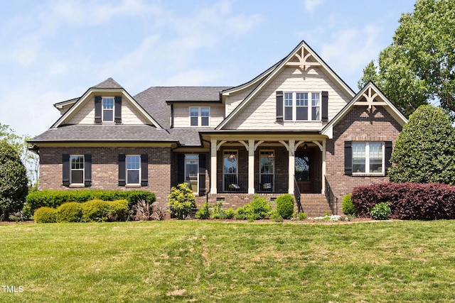 154 Sicily Dr, Clayton, NC 27527 - craftsman-style home featuring covered porch, brick siding, a front lawn, and a shingled roof