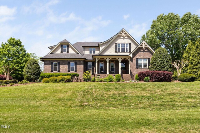 154 Sicily Dr, Clayton, NC 27527 - craftsman house featuring a front lawn, brick siding, and roof with shingles