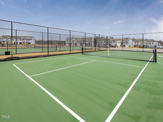 view of sport court featuring a residential view and fence