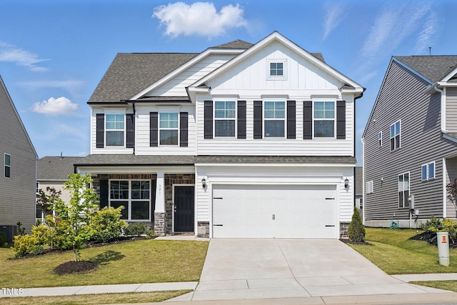 craftsman inspired home with an attached garage, board and batten siding, a front yard, and concrete driveway