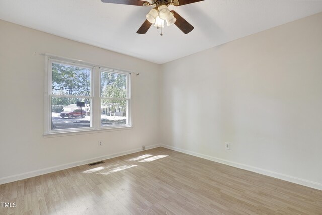 unfurnished room featuring visible vents, light wood finished floors, ceiling fan, and baseboards