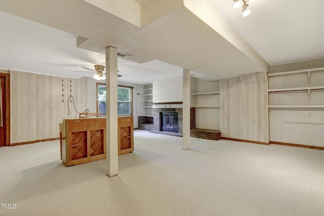 unfurnished living room with a brick fireplace, ceiling fan, visible vents, and carpet flooring
