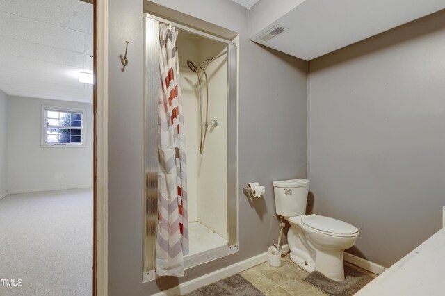 bathroom with visible vents, baseboards, toilet, and a shower stall