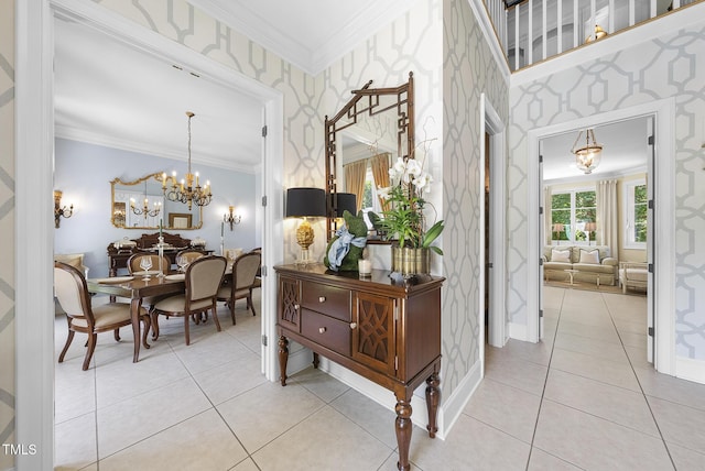 corridor with wallpapered walls, a notable chandelier, ornamental molding, and light tile patterned floors