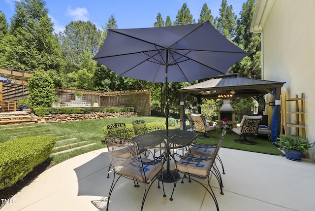 view of patio with outdoor dining area and a gazebo