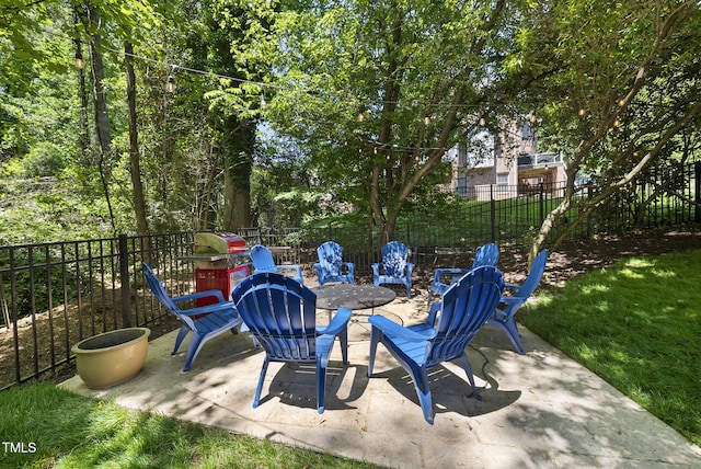 view of patio / terrace featuring fence and a fire pit
