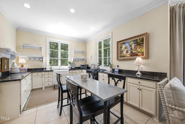 dining area featuring recessed lighting, ornamental molding, light tile patterned floors, and a toaster