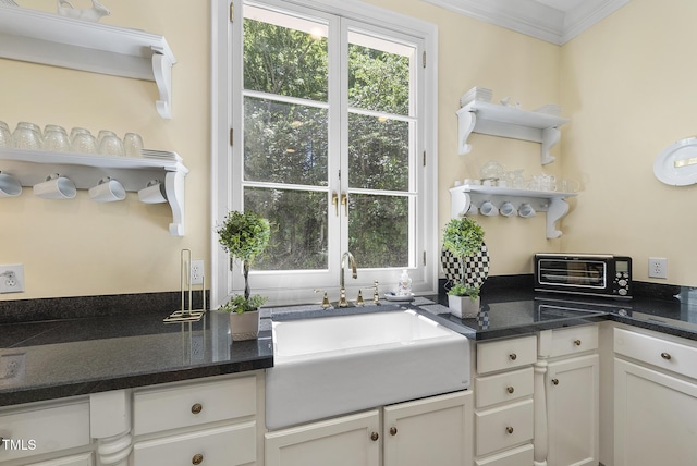 kitchen featuring open shelves, plenty of natural light, a sink, and a toaster