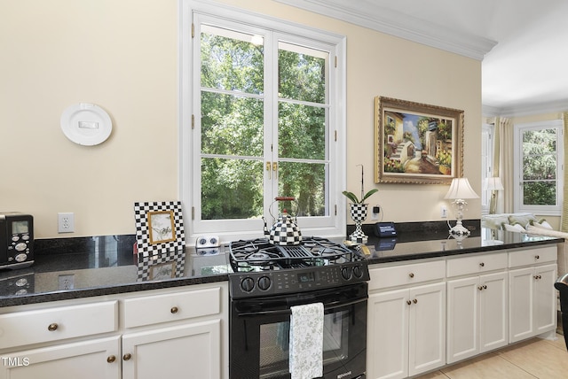 kitchen with crown molding, white cabinetry, dark stone countertops, and black gas stove