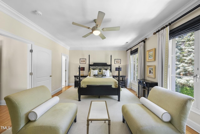 bedroom with baseboards, ceiling fan, multiple windows, and ornamental molding
