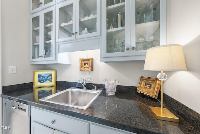 bar with stainless steel dishwasher and a sink