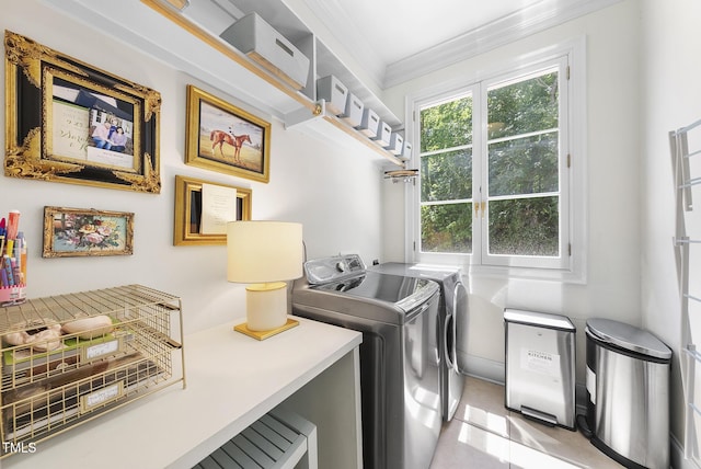 laundry room with laundry area, ornamental molding, and washer and clothes dryer