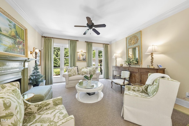carpeted living room with crown molding, a ceiling fan, and baseboards