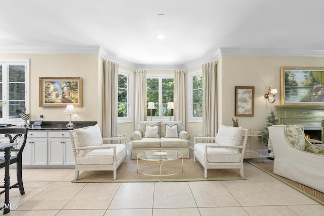 sitting room featuring crown molding, light tile patterned floors, and a lit fireplace