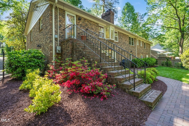 3420 Sheridan Dr, Durham, NC 27707 - ranch-style house with brick siding, a chimney, and stairs
