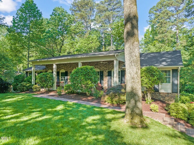 3420 Sheridan Dr, Durham, NC 27707 - view of front facade with a front yard, brick siding, and a porch