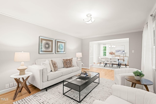 3420 Sheridan Dr, Durham, NC 27707 - living area featuring light wood finished floors, baseboards, crown molding, and a chandelier