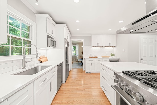 3420 Sheridan Dr, Durham, NC 27707 - kitchen featuring a sink, range hood, healthy amount of natural light, decorative backsplash, and recessed lighting