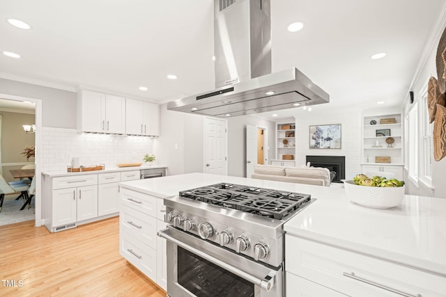 3420 Sheridan Dr, Durham, NC 27707 - kitchen with exhaust hood, high end stainless steel range oven, recessed lighting, crown molding, and light countertops