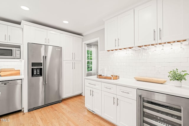 3420 Sheridan Dr, Durham, NC 27707 - kitchen with stainless steel appliances, beverage cooler, light countertops, ornamental molding, and backsplash